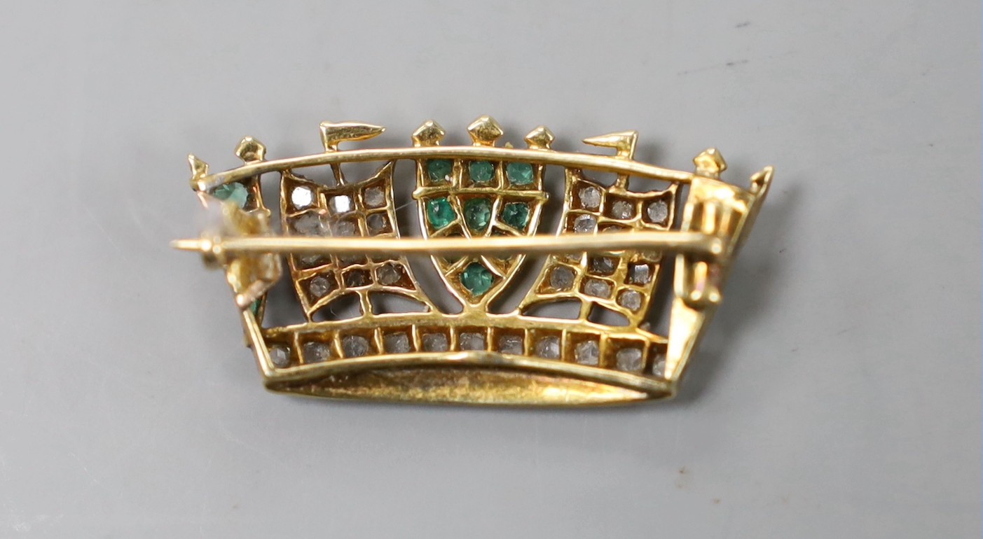 An early 20th century yellow metal, emerald and diamond set coronet brooch, 30mm, gross weight 4.4 grams.